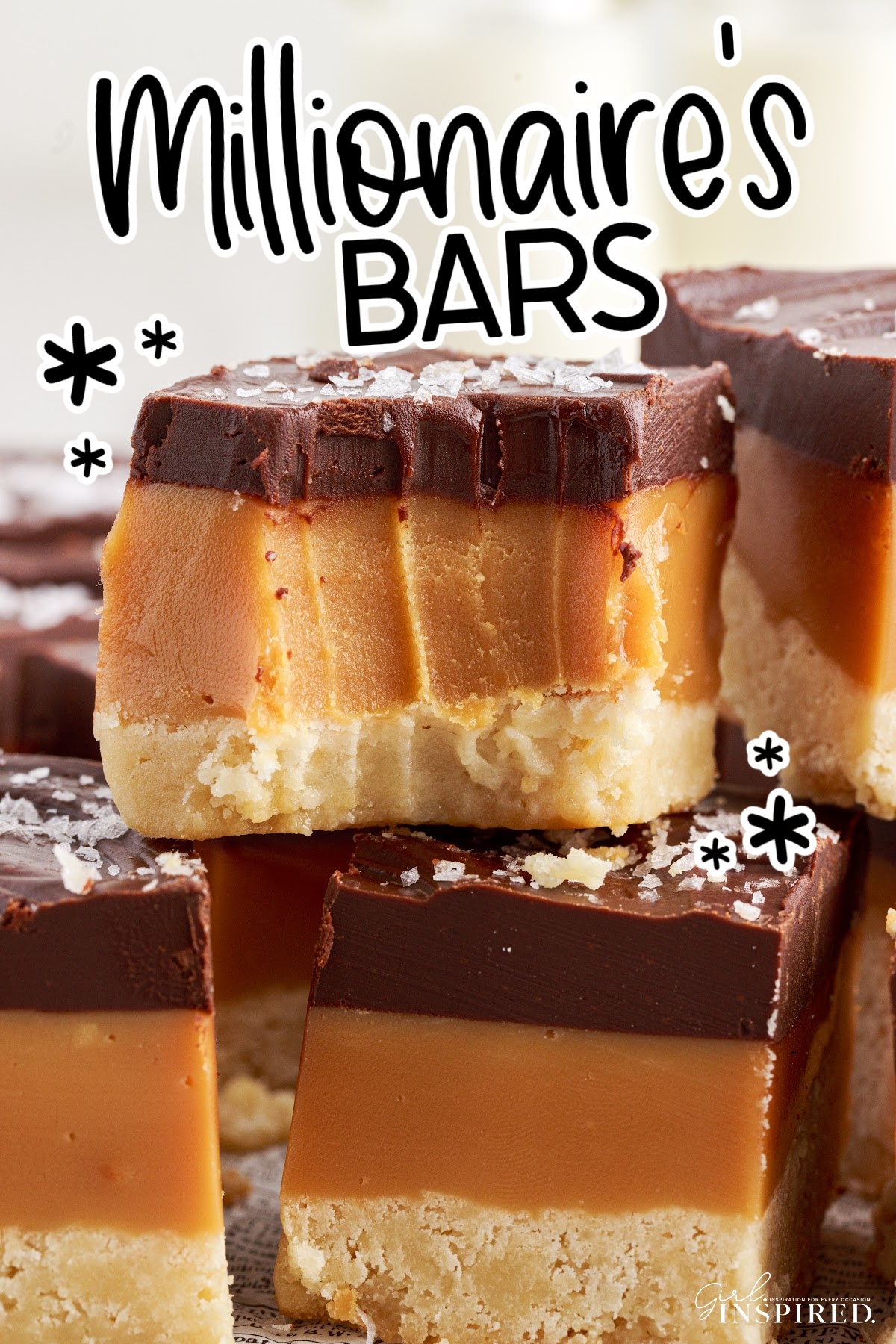 Millionaire Bars stacked on each other with a bite taken from the top one with text overlay.