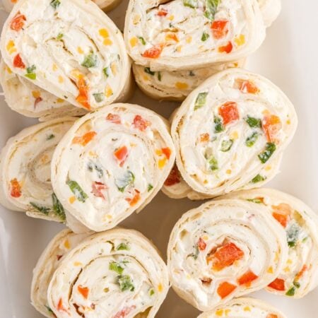 Sliced ranch pinwheels on a white plate.