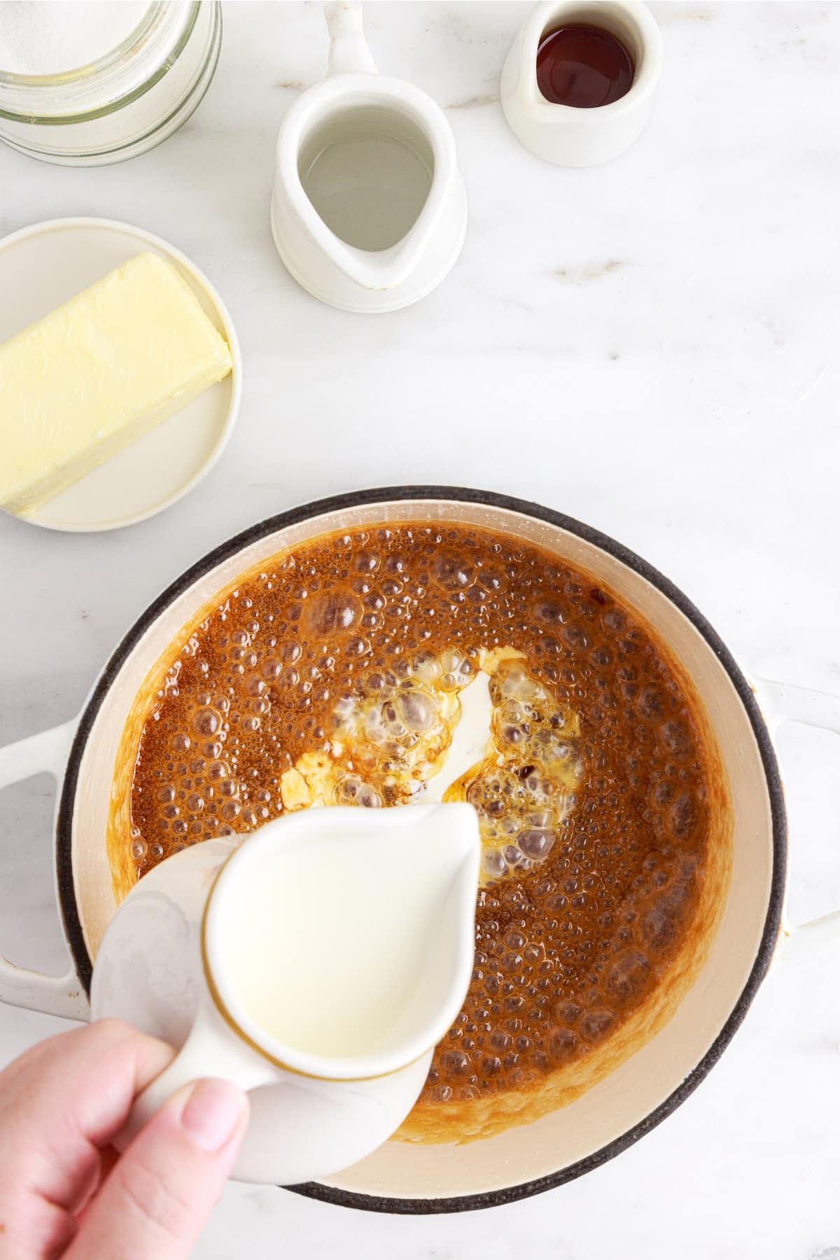 Heavy cream added to caramelized sugar.