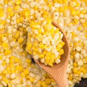 Close up of Honey Butter Skillet Corn on a wooden spoon.