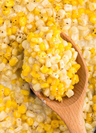 Close up of Honey Butter Skillet Corn on a wooden spoon.
