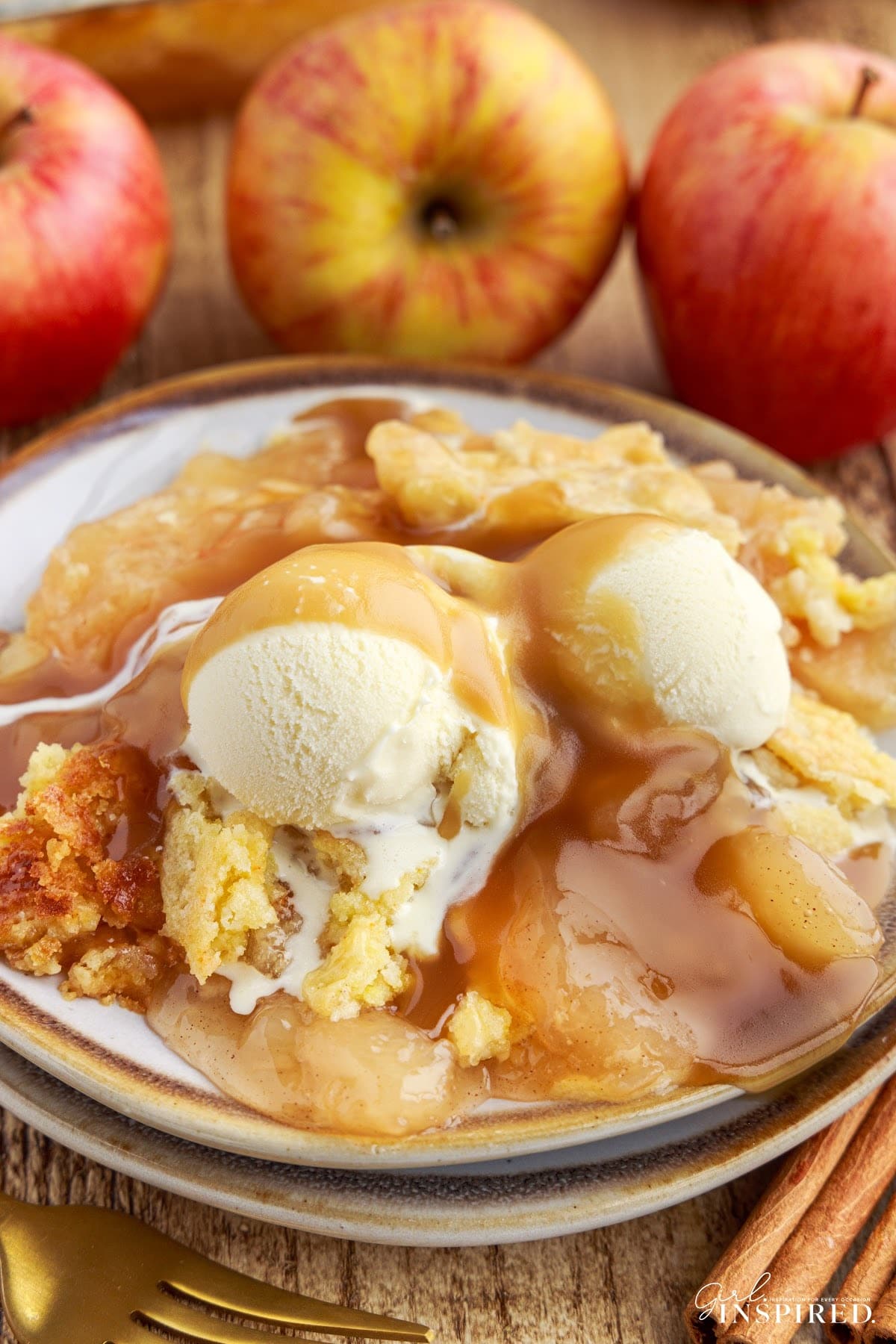 A serving of Apple Pie Dump Cake with ice cream on a plate.