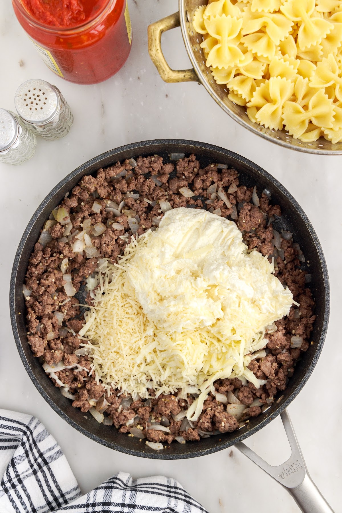 Ricotta and mozzarella cheese added to the ground beef mixture.
