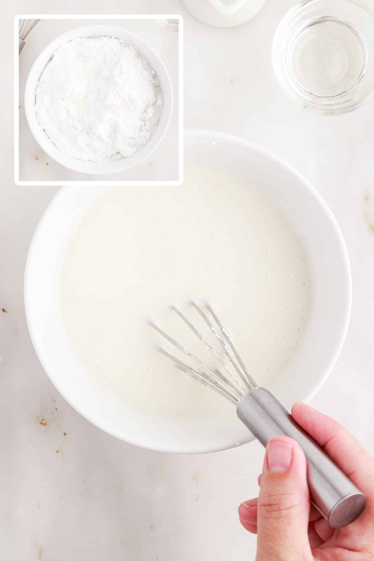 Powdered sugar milk and corn syrup in a mixing bowl and mixed together.