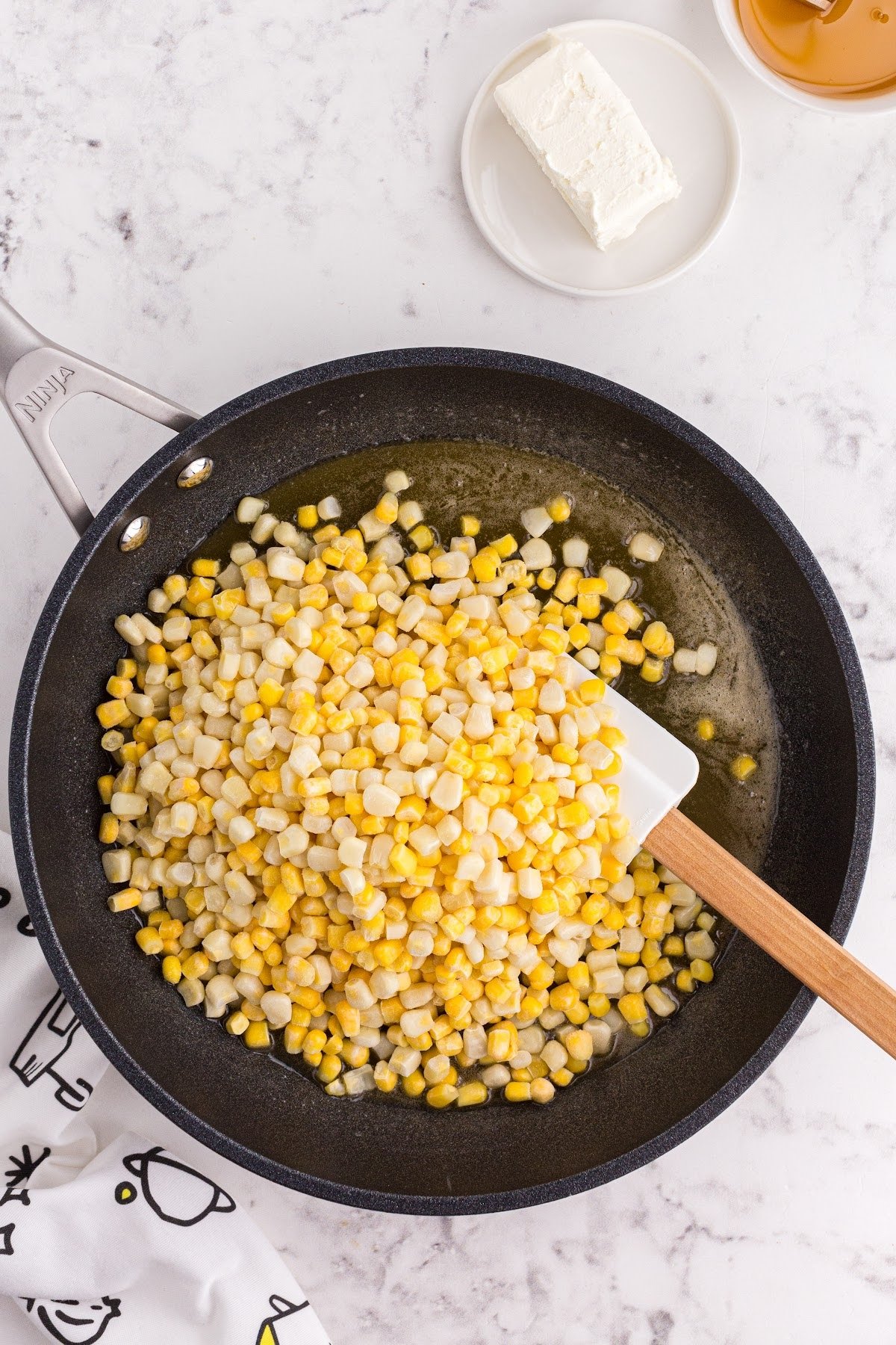 Corn added to buttered skillet.