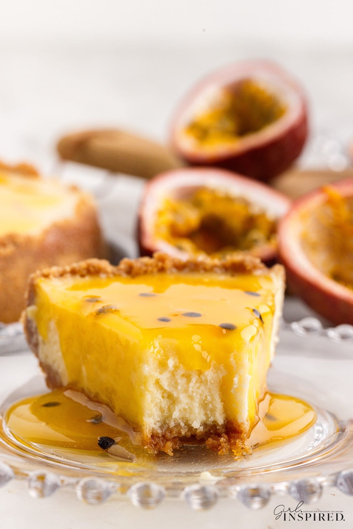 A slice of Passionfruit Cheesecake with a bite missing.