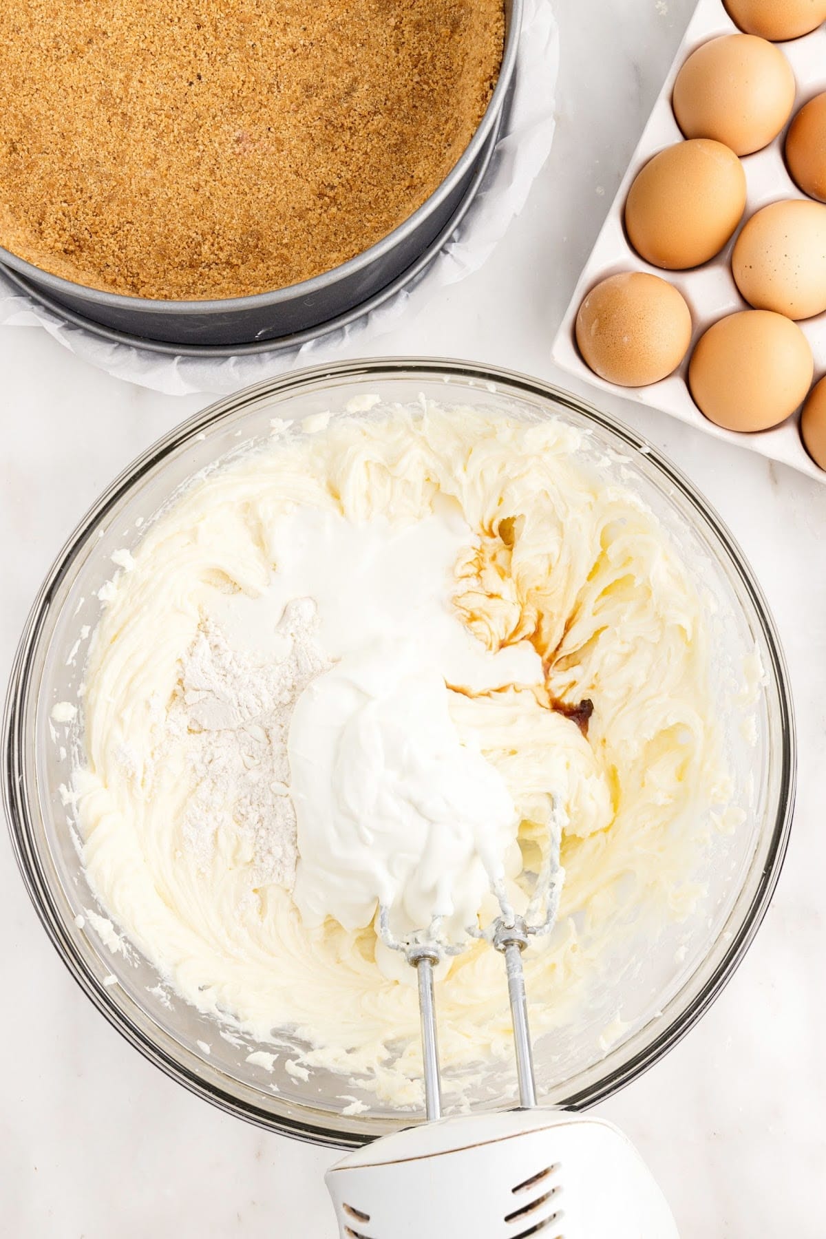 Salt, flour, heavy cream, and sour cream in a mixing bowl with a hand mixer.