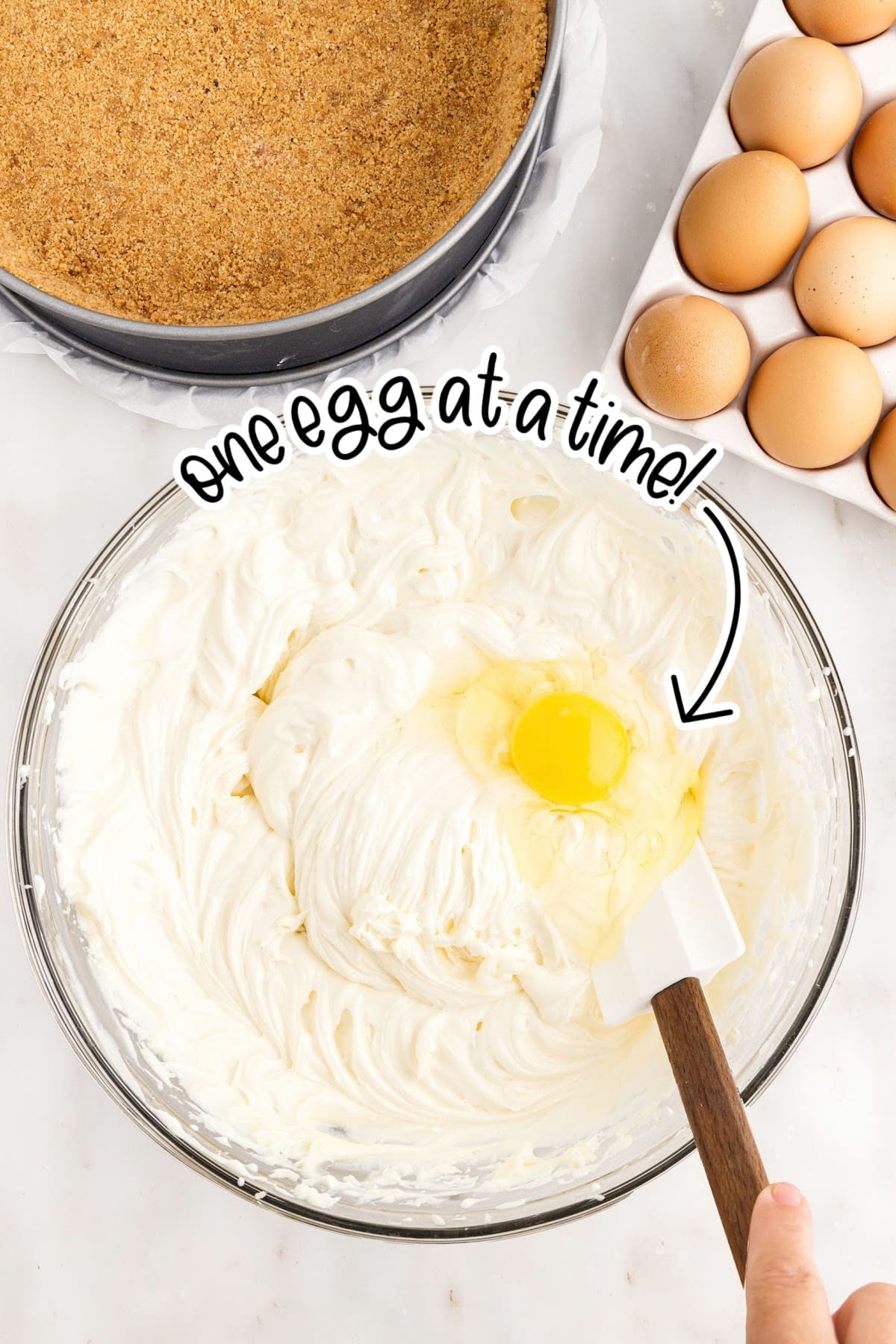 Egg added to the cream cheese mixture with text overlay.