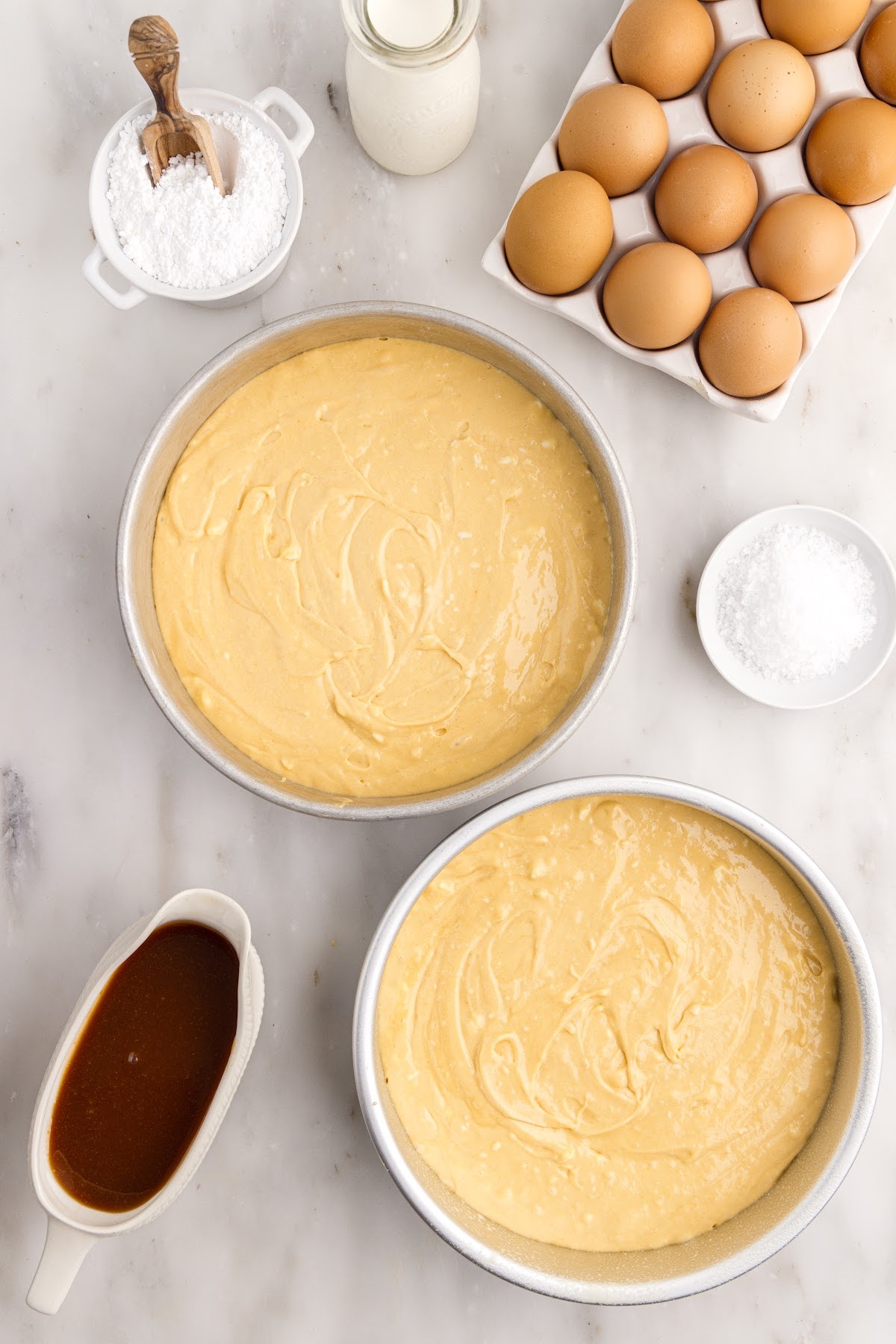Two round cake pans filled with Salted Caramel Cake batter.