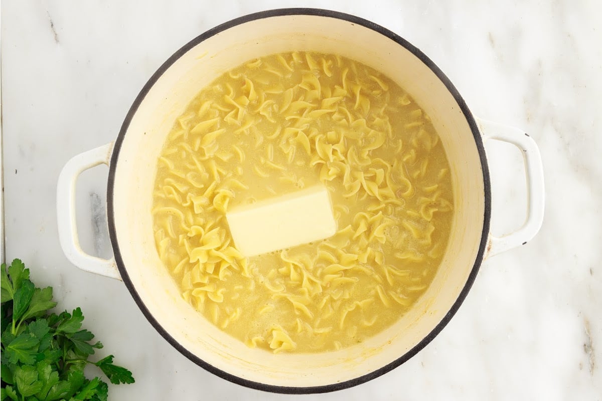 Butter added to noodles in dutch oven.