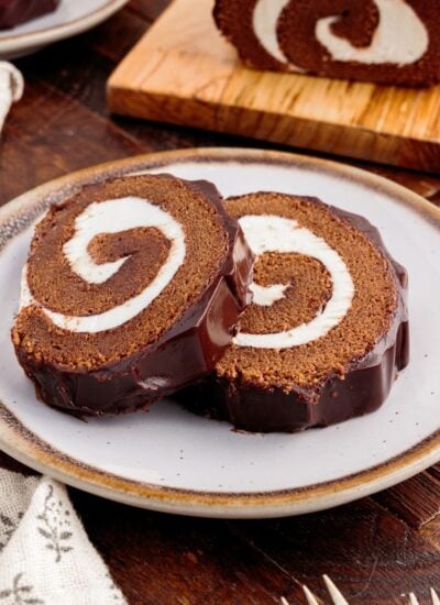 Close up of two slices of Chocolate Swiss Roll on a platter.