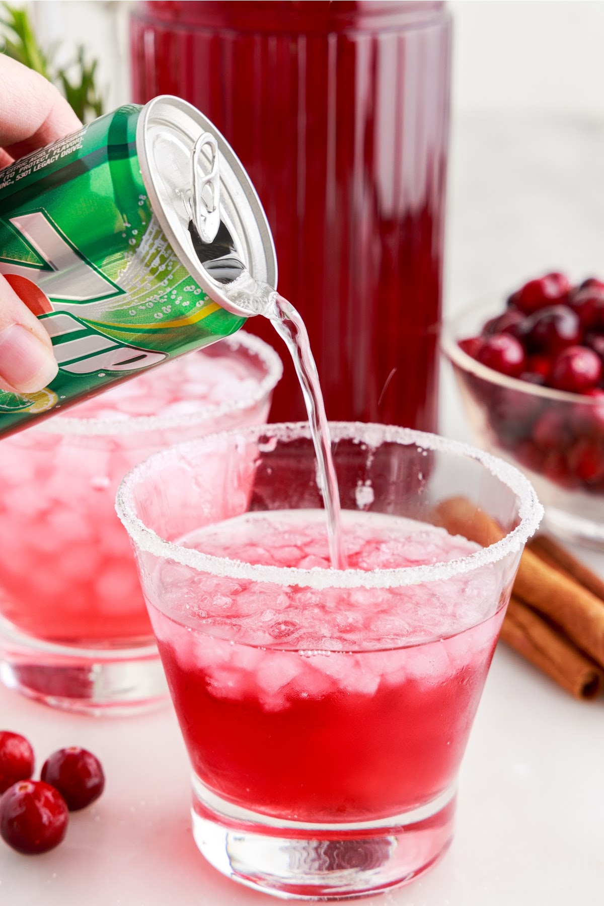Seven up being poured over Christmas Cranberry Cocktail.