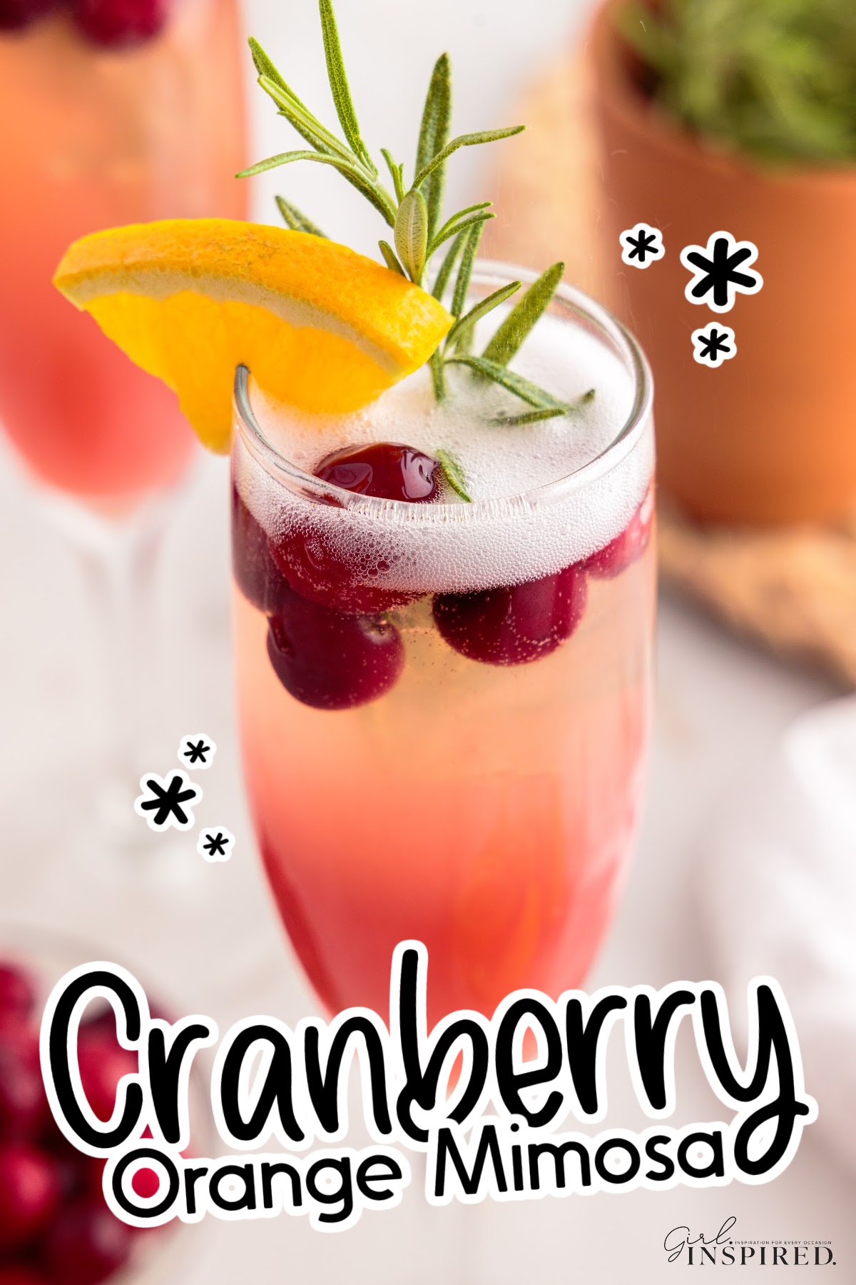 Close up of a Cranberry Orange Mimosa with text overlay.