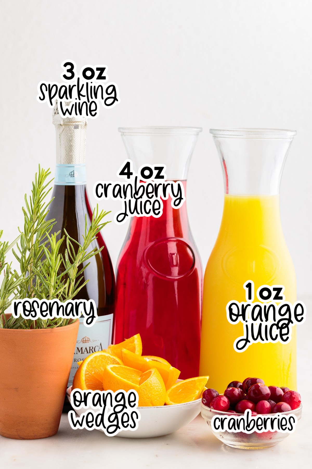 Ingredients needed to make Cranberry Orange Mimosas with text overlay.