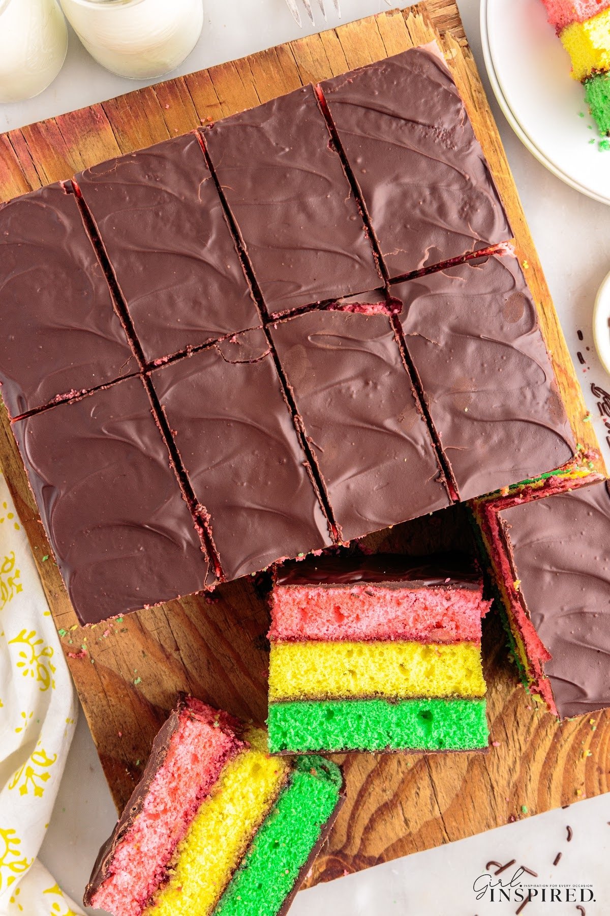 Overhead view of Italian Rainbow Cake cut into rectangles with two pieces on their side.