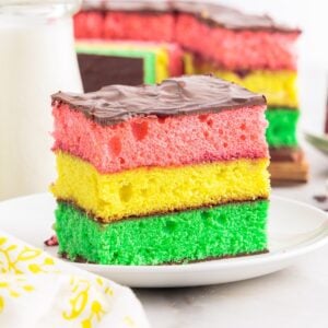 A plate with a slice of Italian Rainbow Cake on it.