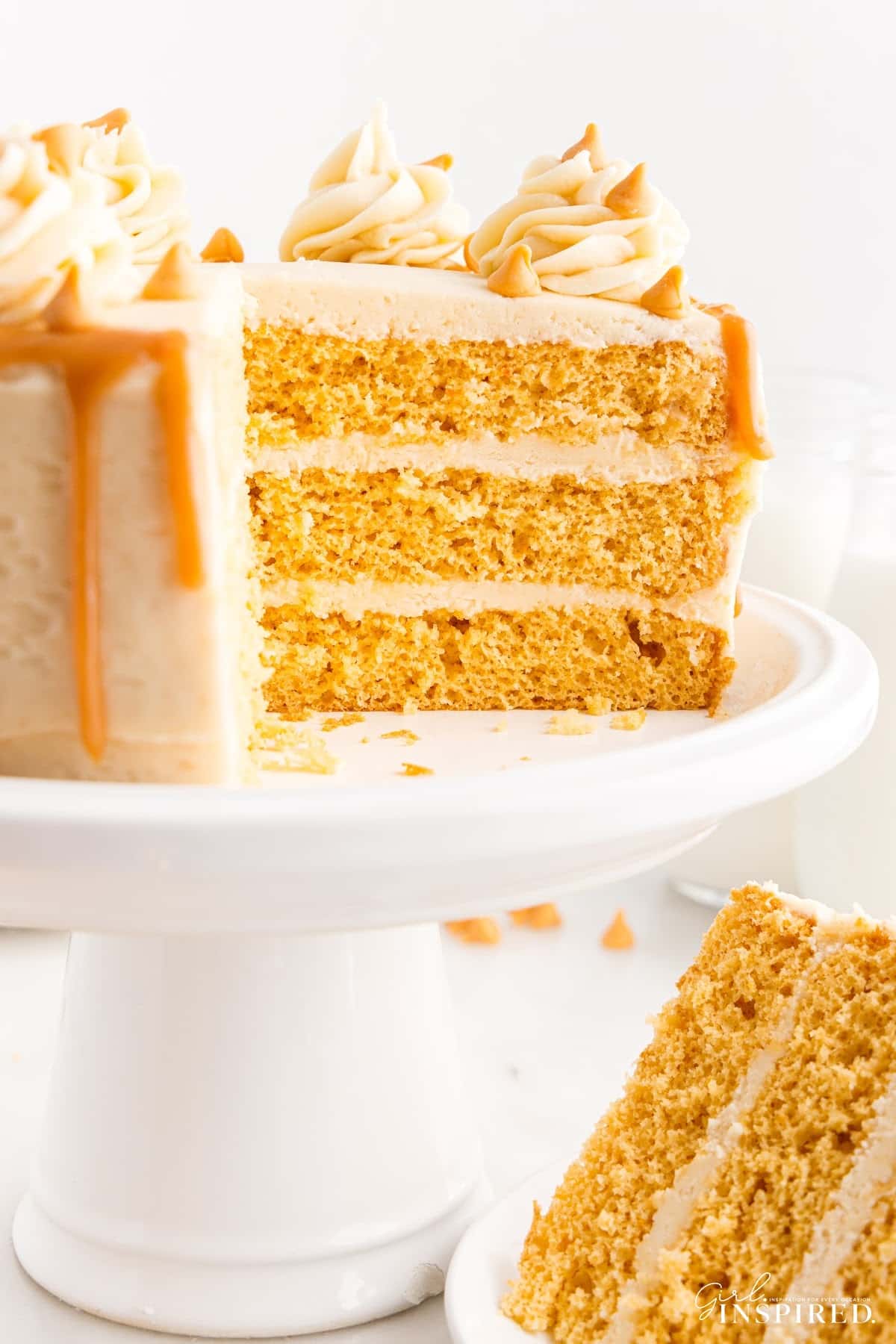 A Butterscotch Cake with slices missing and a slice on a plate.