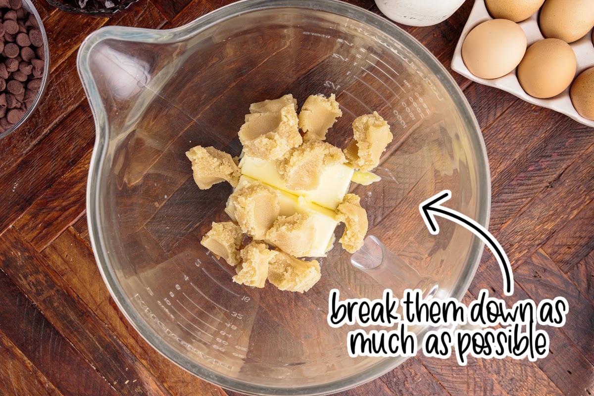 Butter and almond paste in a bowl with text overlay, "break them down as much as possible."