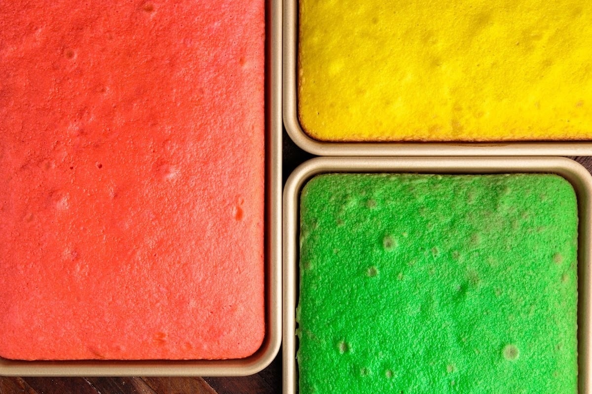 Overhead close up of three pans of Italian Rainbow Cake after being baked.