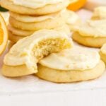 Front close up of Orange Cookies, a bite taken from one.