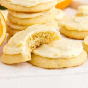 Front close up of Orange Cookies, a bite taken from one.