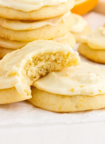 Front close up of Orange Cookies, a bite taken from one.
