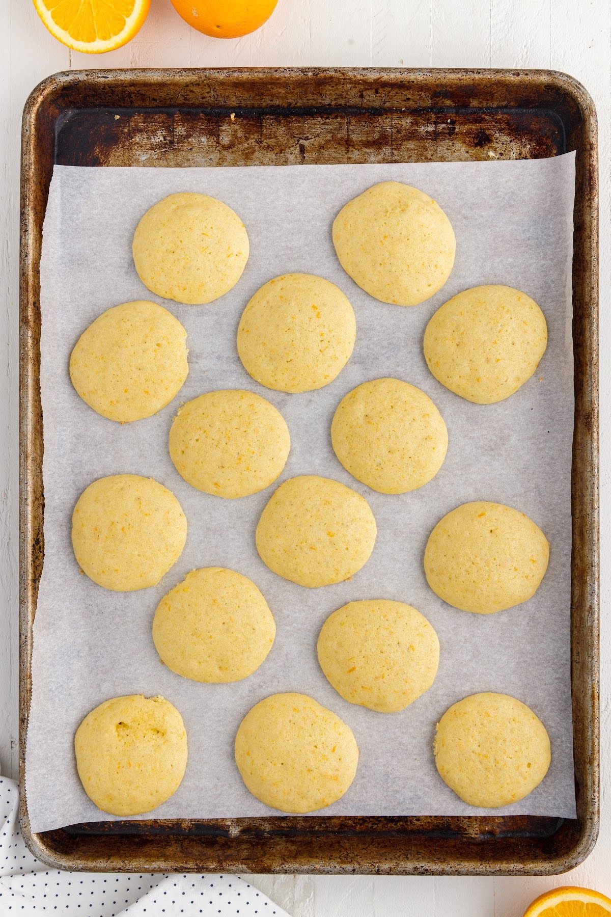 Orange Cookies after being baked on a cookie sheet.