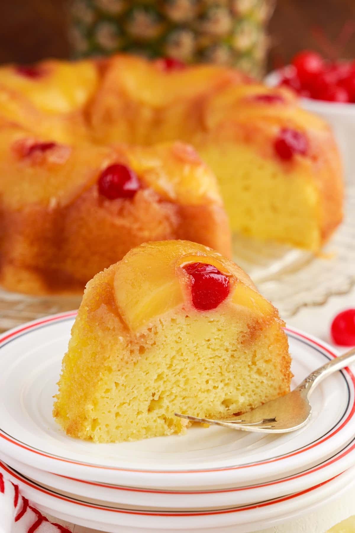 A slice of Pineapple Upside Down Bundt Cake on a plate with a fork.