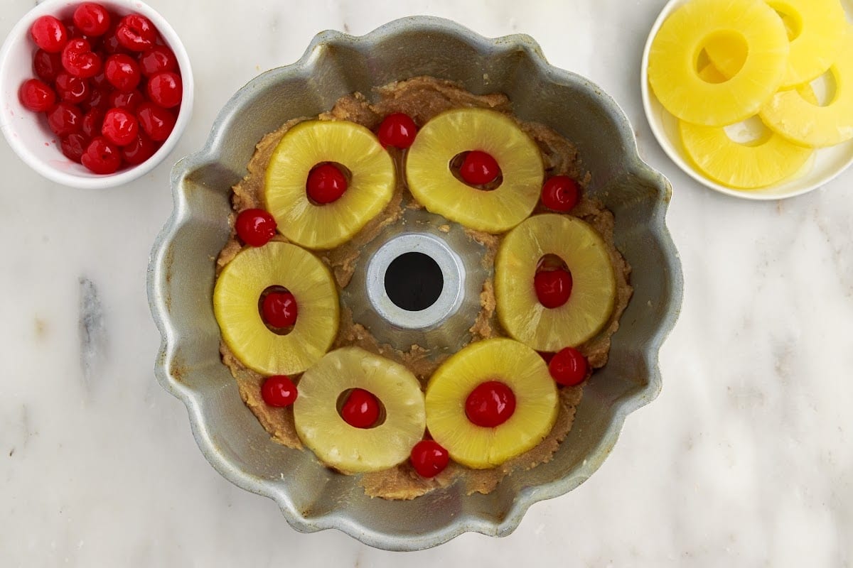 Pineapple slices and cherries added to the mixture.