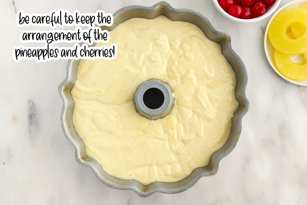 Cake mix mixture poured on top of pineapples and cherries with text overlay.