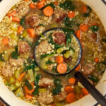 A pot of Italian Wedding Soup with a ladle.