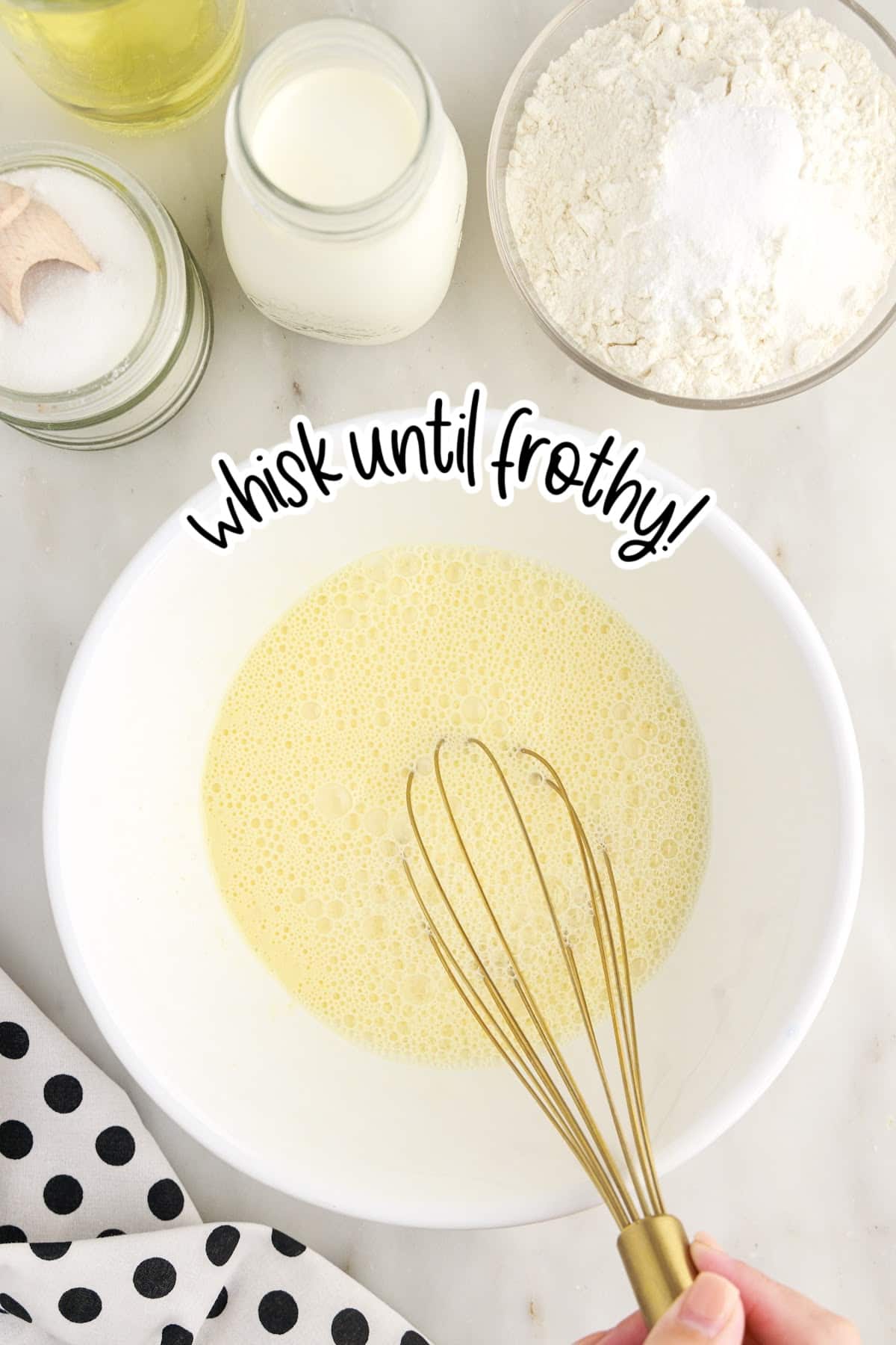 Egg mixed in a mixing bowl with a whisk with text overlay.