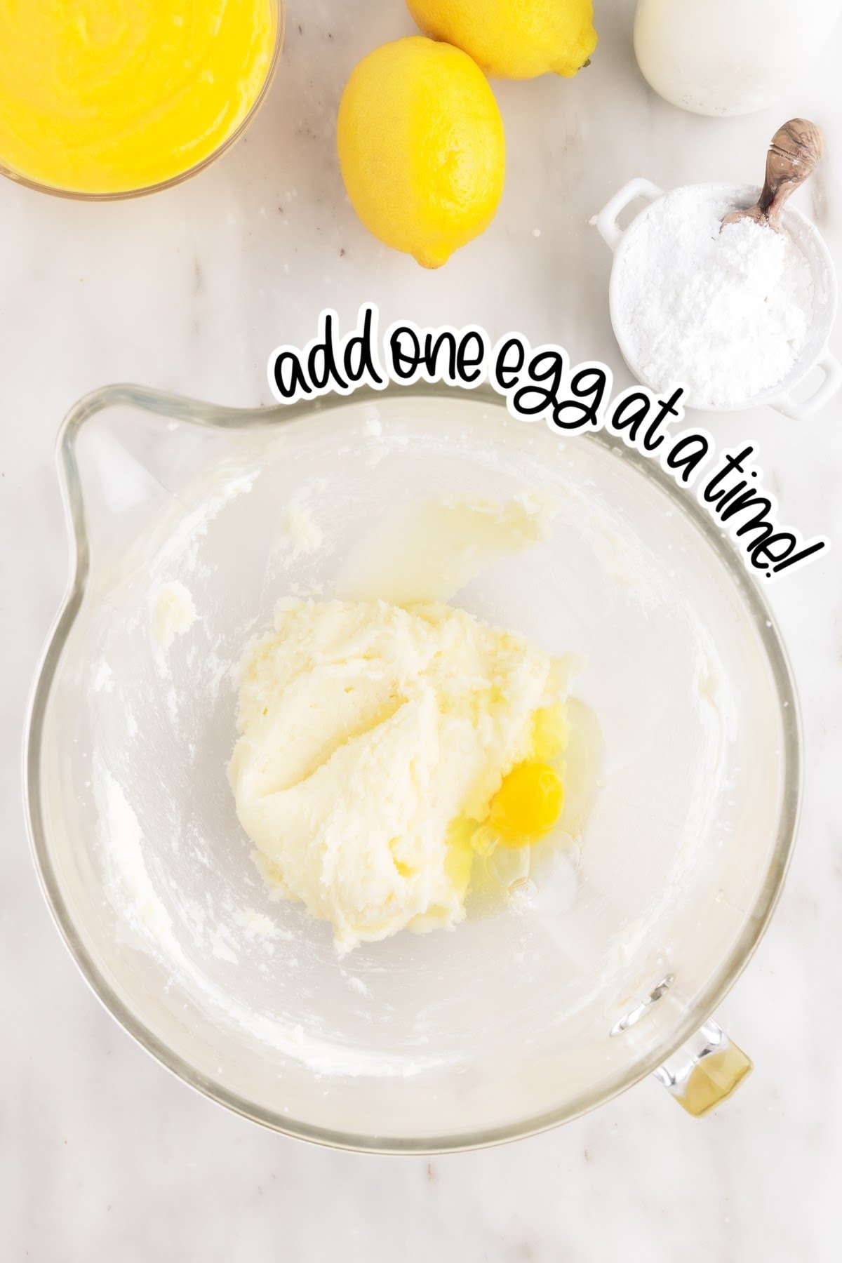 Eggs added to the sugar mixture with text overlay.