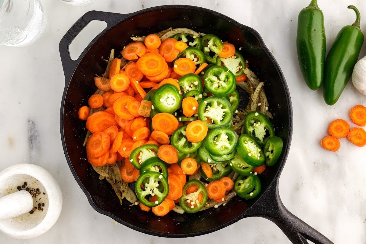 Carrots and jalapenos added to the skillet.
