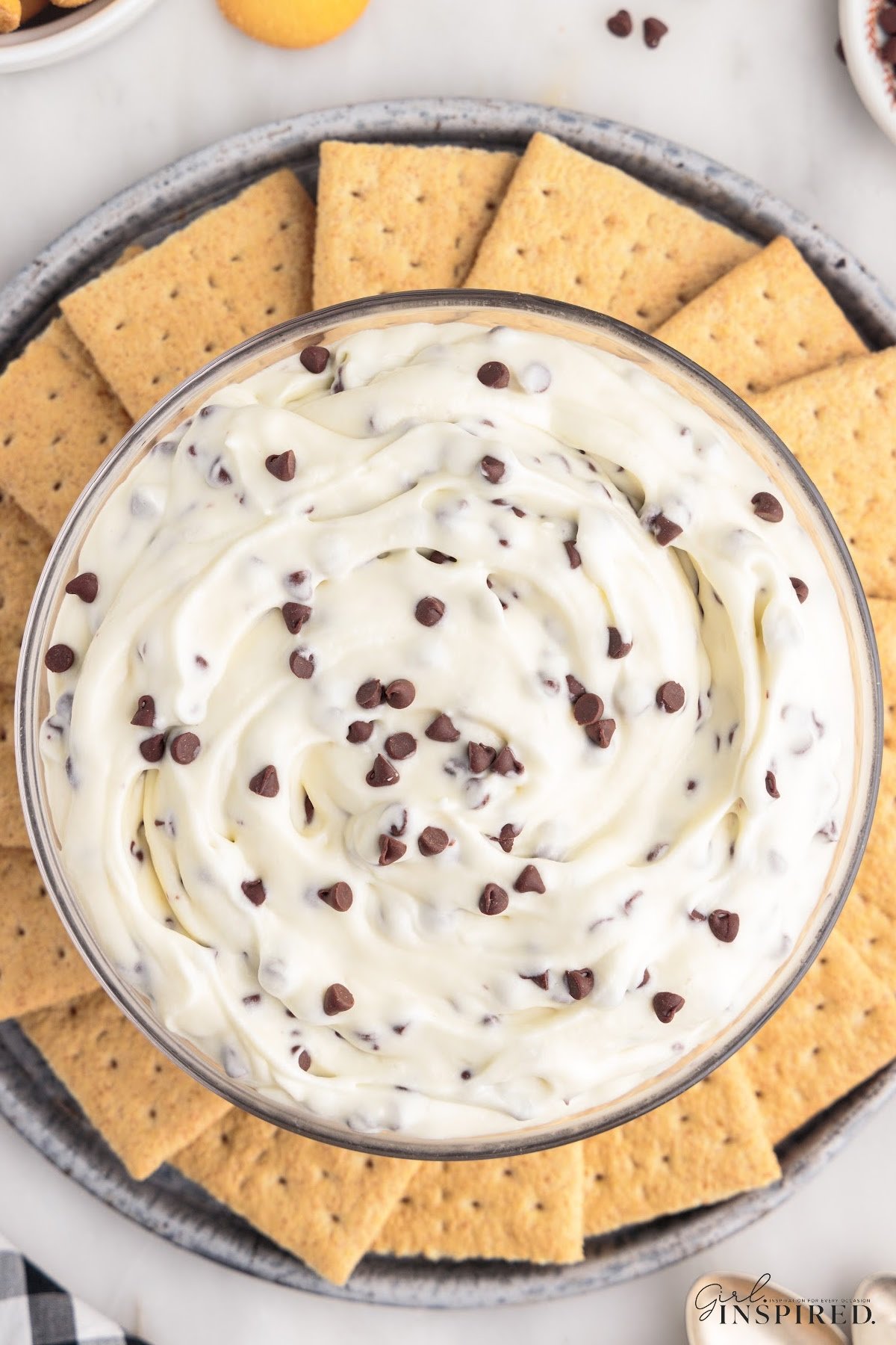 Large bowl of booty dip surrounded by graham crackers.