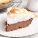 A slice of completed Chocolate Meringue Pie on a plate.