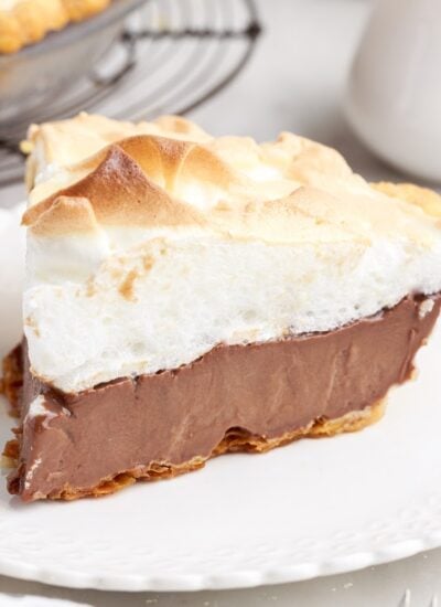 A slice of completed Chocolate Meringue Pie on a plate.