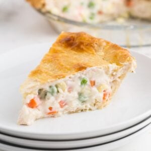A slice of creamy chicken pot pie on a small white plate.