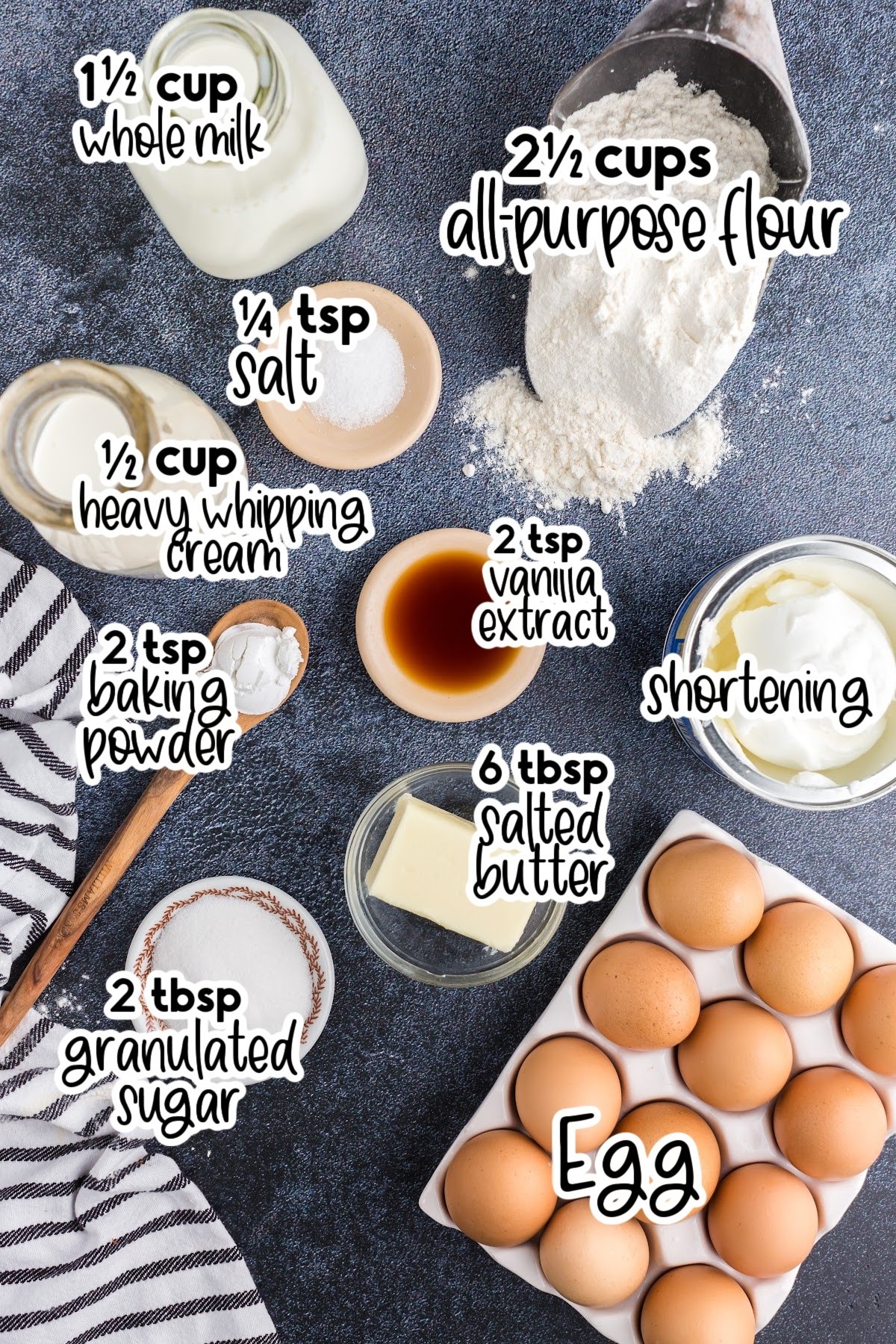 Individual ingredients needed for funnel cake fries, like a scoop of flour and a jug of cream, set out with text labels.