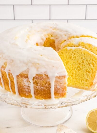 Lemon Chiffon Cake with glaze on a cake dish.