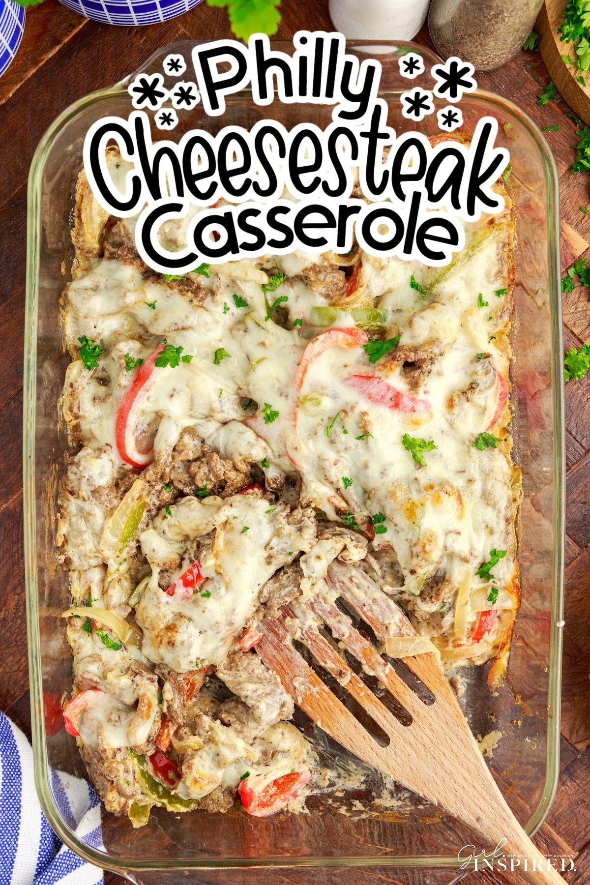 Overhead view of Philly Cheesesteak Casserole with a serving missing with text overlay.