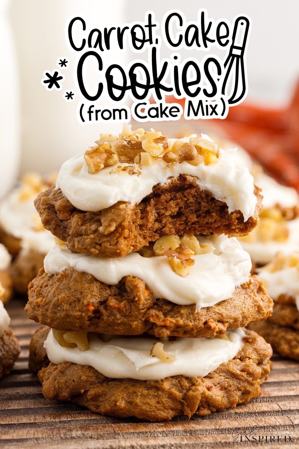 Carrot Cake Cookies with frosting on top and a bite out of the top cookie, with text overlay.