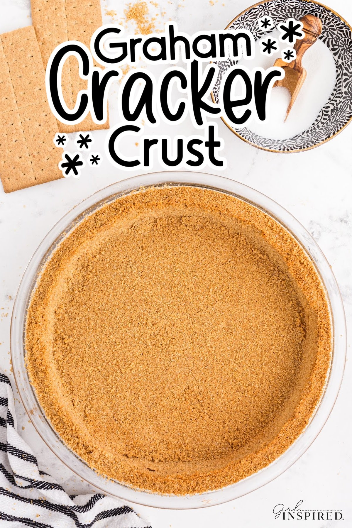 A graham cracker pie crust in a glass pie plate with text overlay.