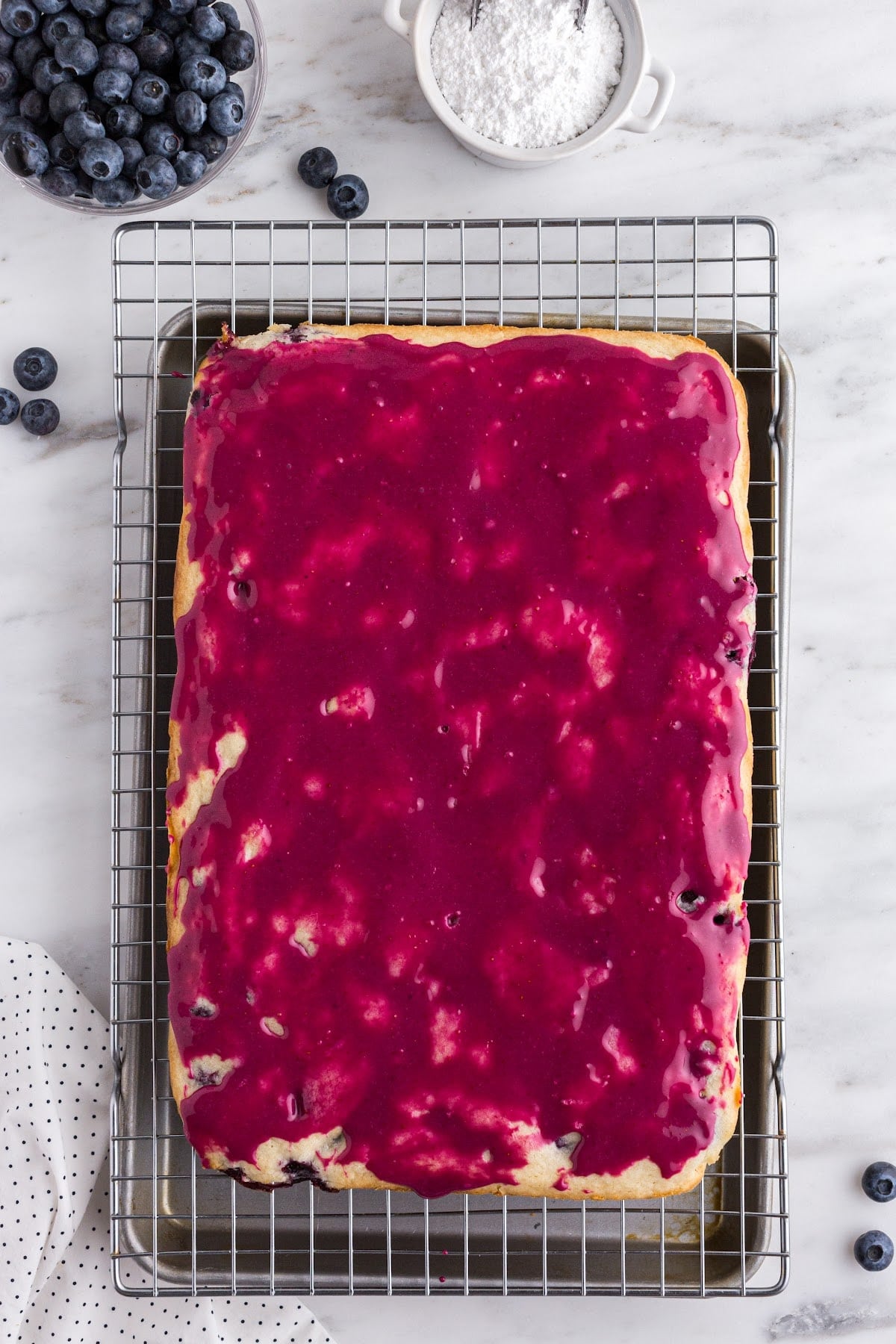 Pouring the glaze over the cooked blondies.