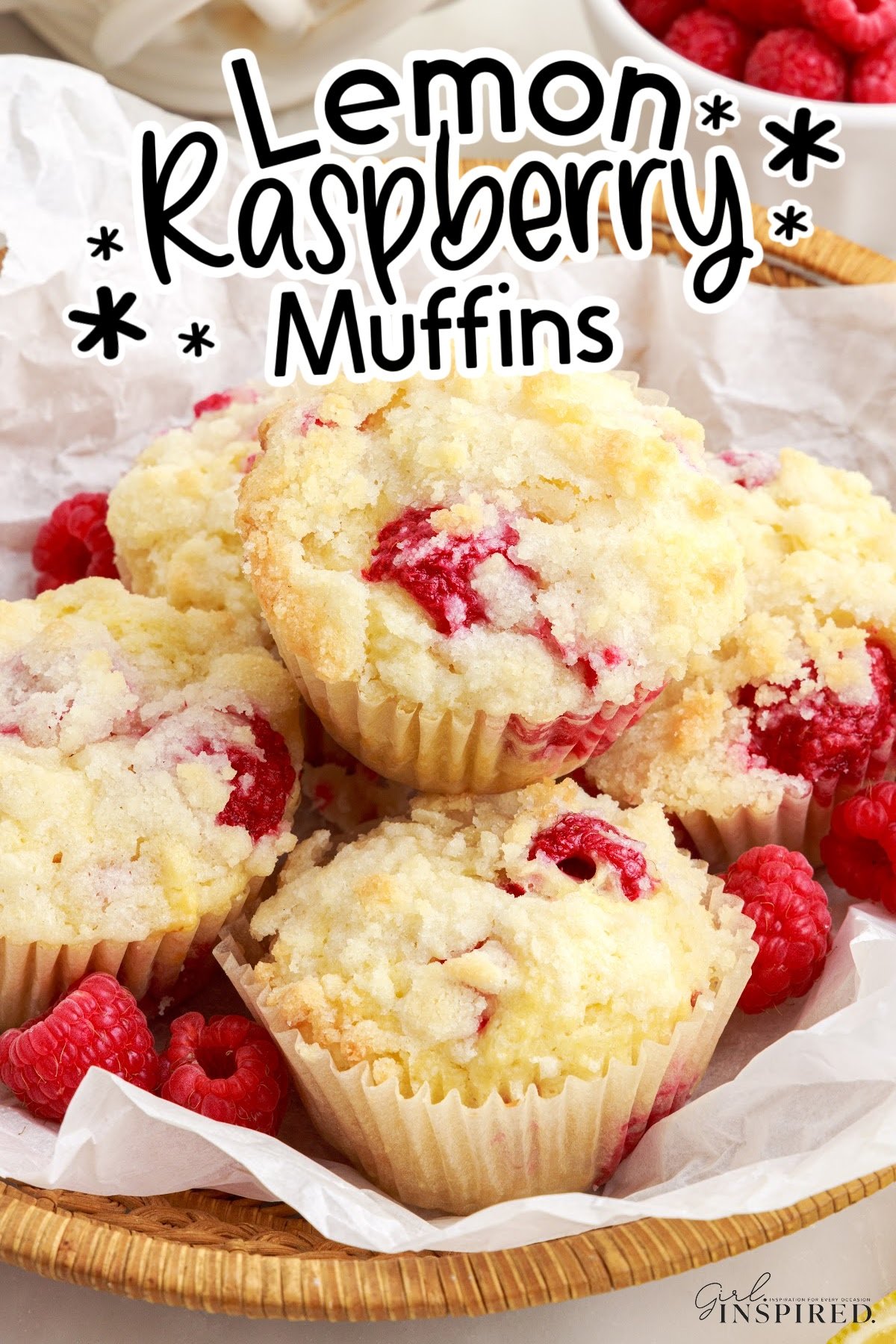 Pile of lemon raspberry muffins in a bread basket with text title overlay.