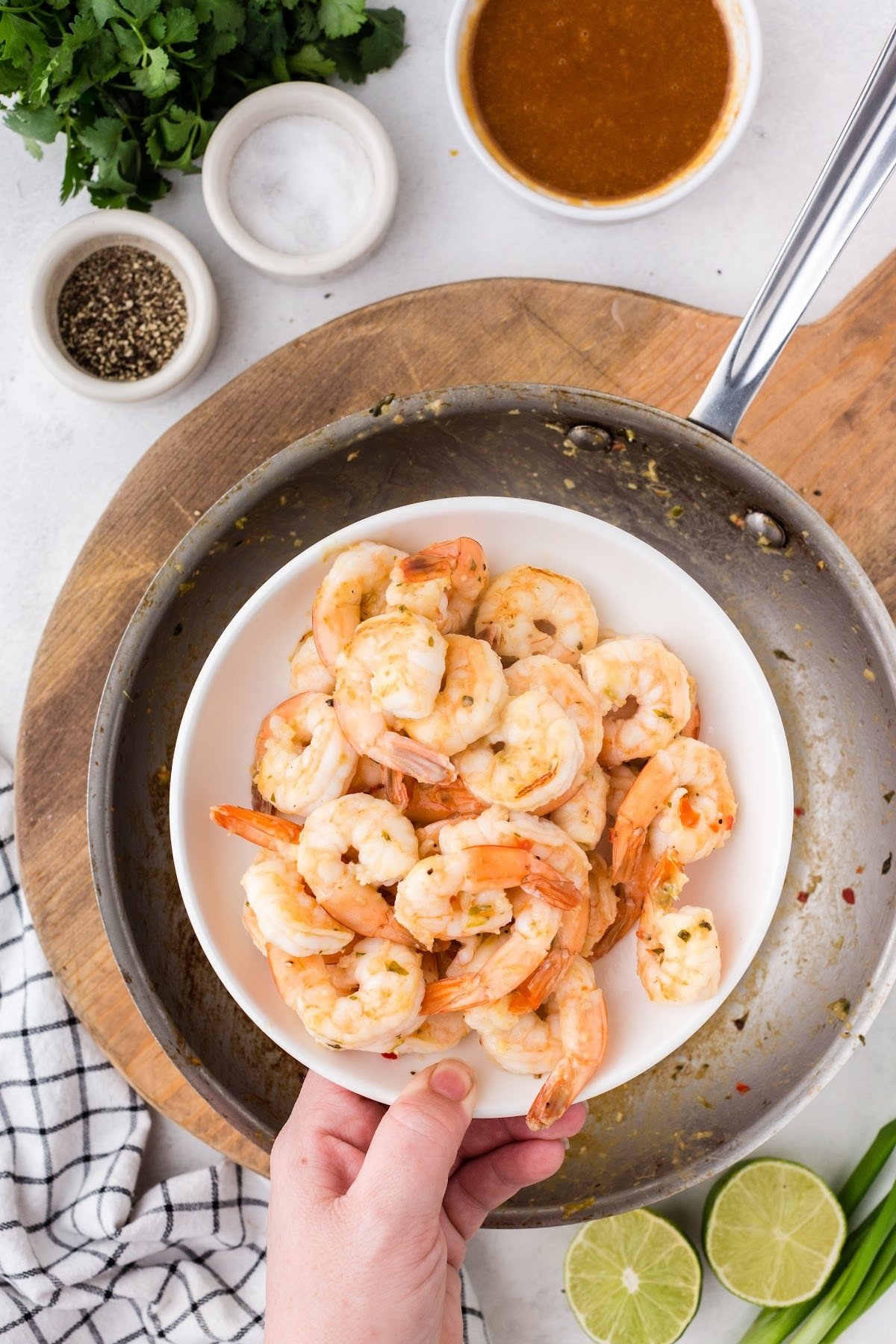 Shrimp removed from the pan and put on a plate to cool off and stop cooking.