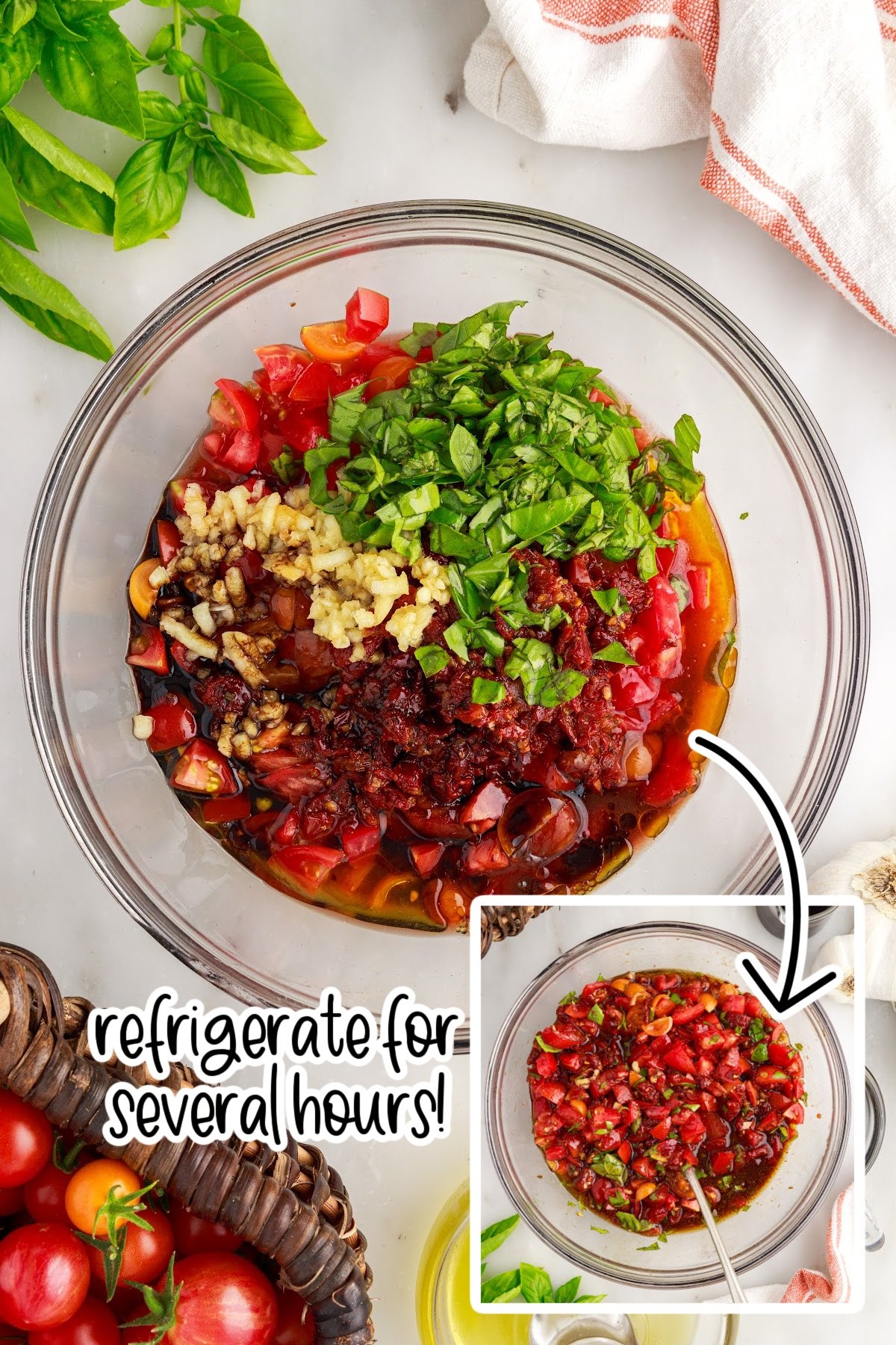 Bruschetta topping ingredients in a large glass mixing bowl.