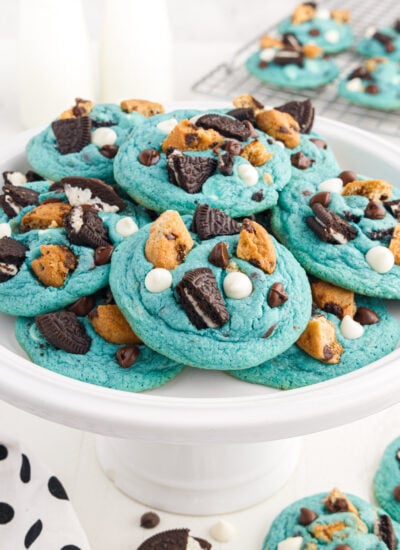 A cake stand piled with Cookie Monster Cookies.