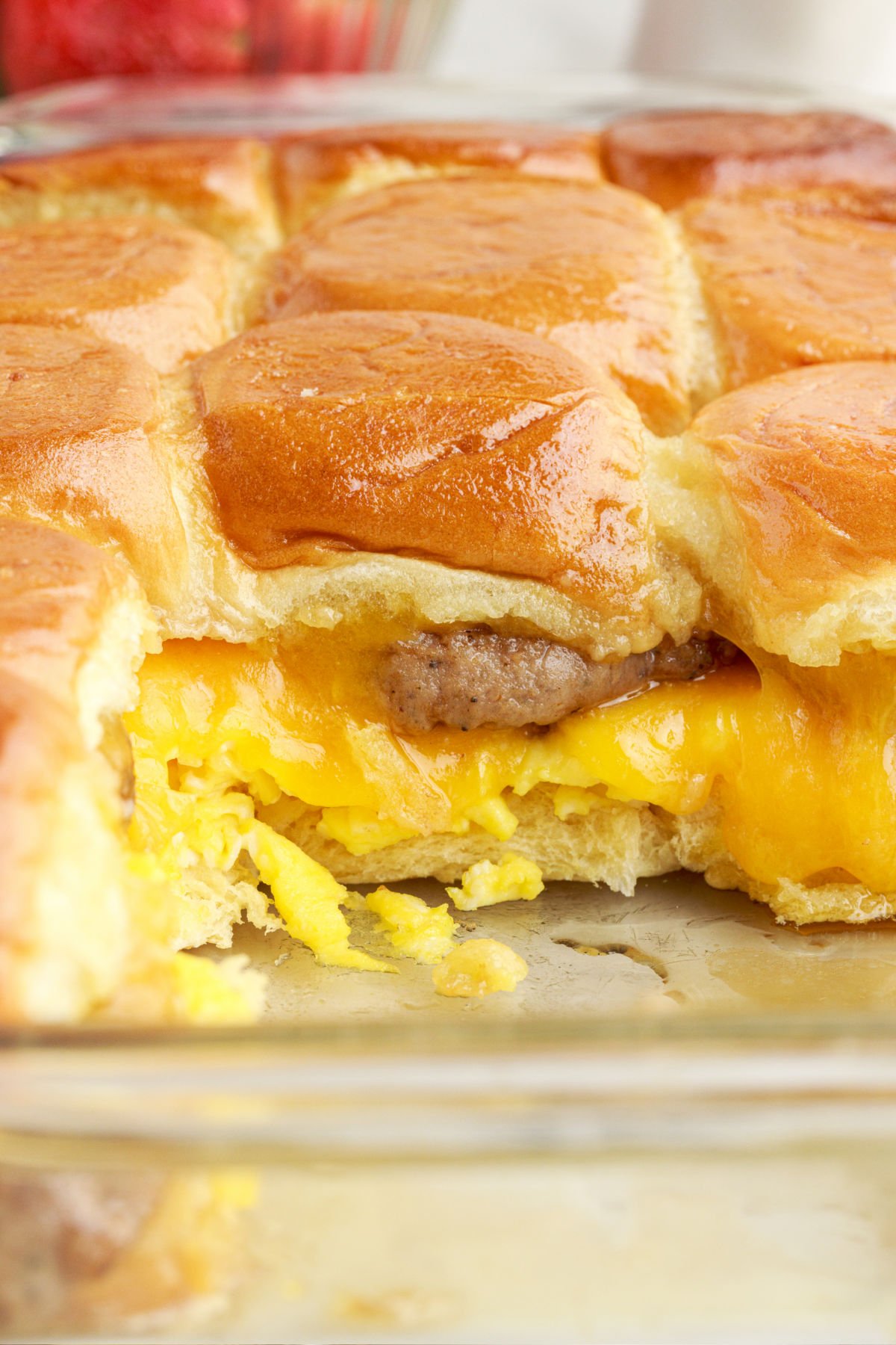 Baking dish filled with Breakfast Sliders, and two removed.