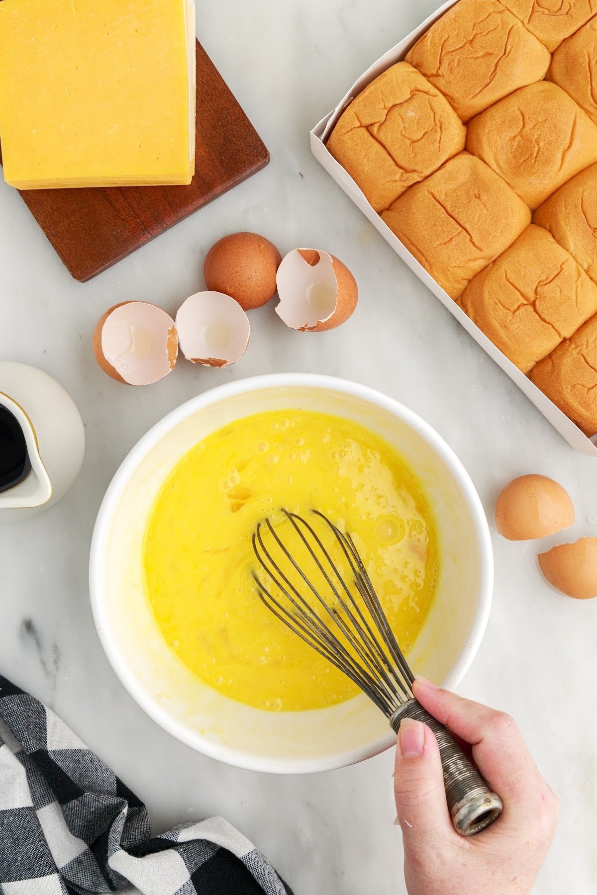 Wisking the eggs in a bowl to get ready to scramble.